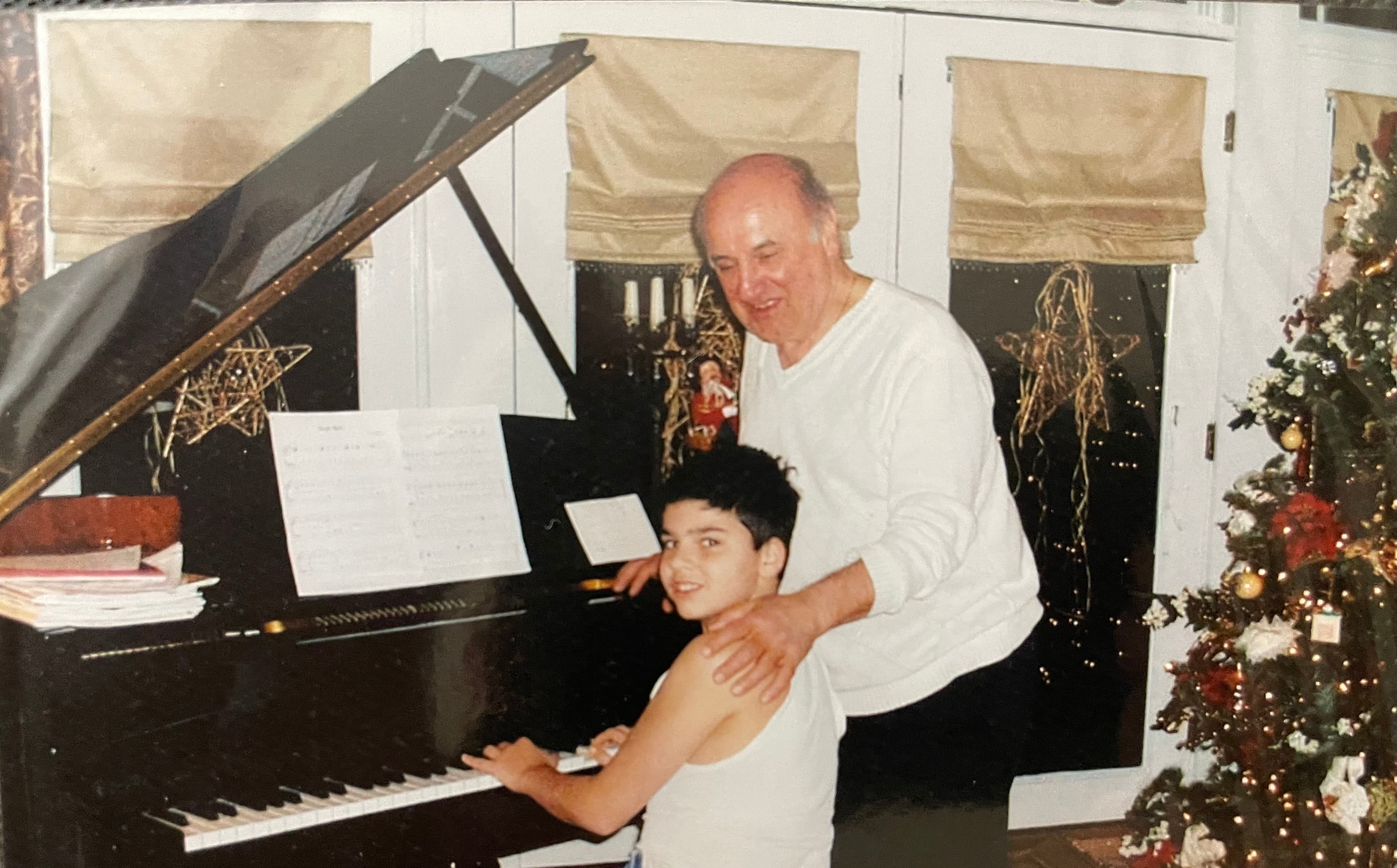 Young Carmine DiCesare at the piano with his grandfather
